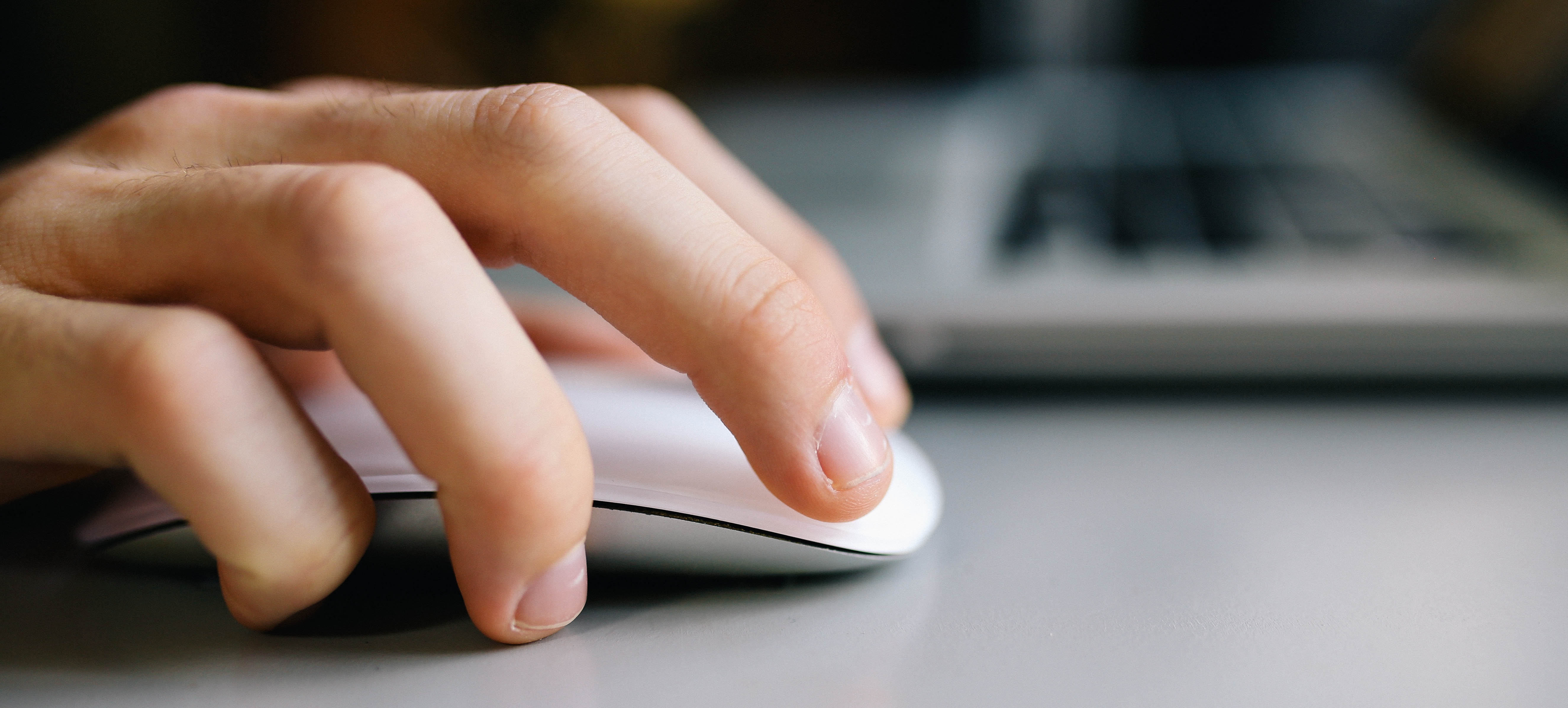 A desk with a laptop and glasses on top